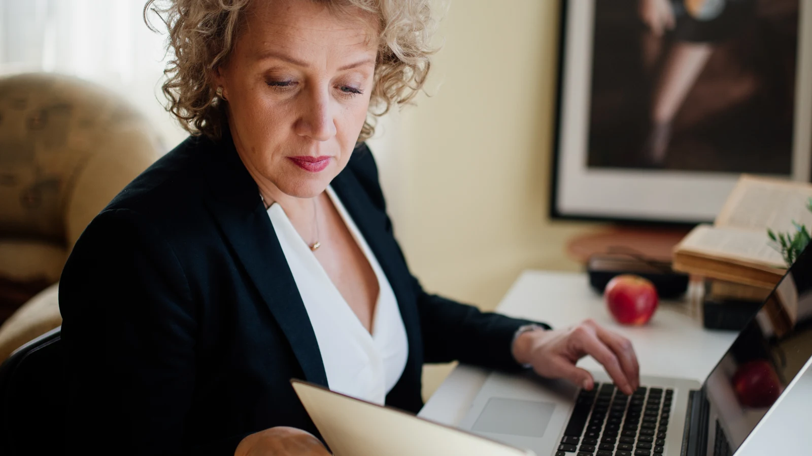 professional writing review on a laptop with documents